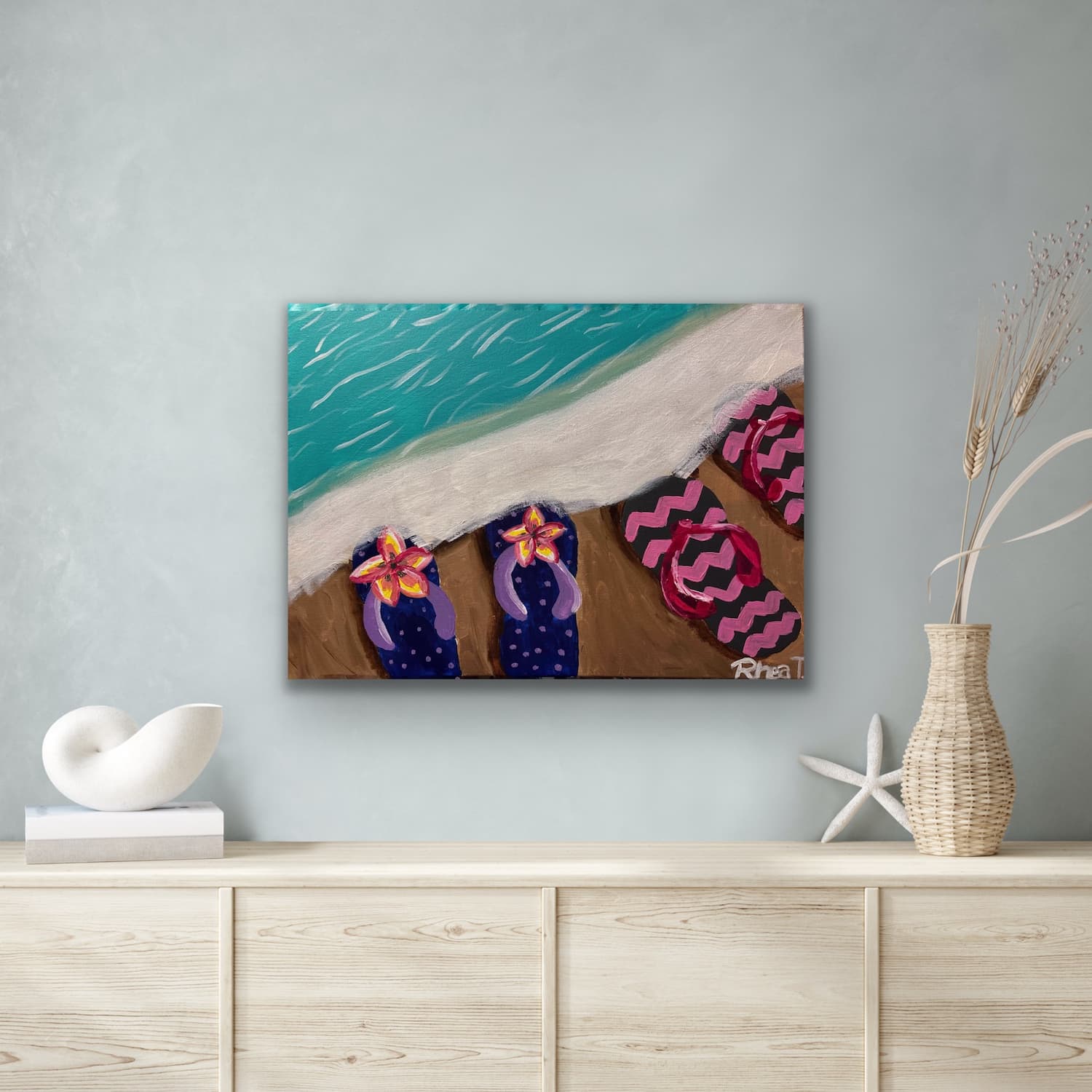 Flip Flops at the Shore painting shown mocked up on a coastal-styled wall